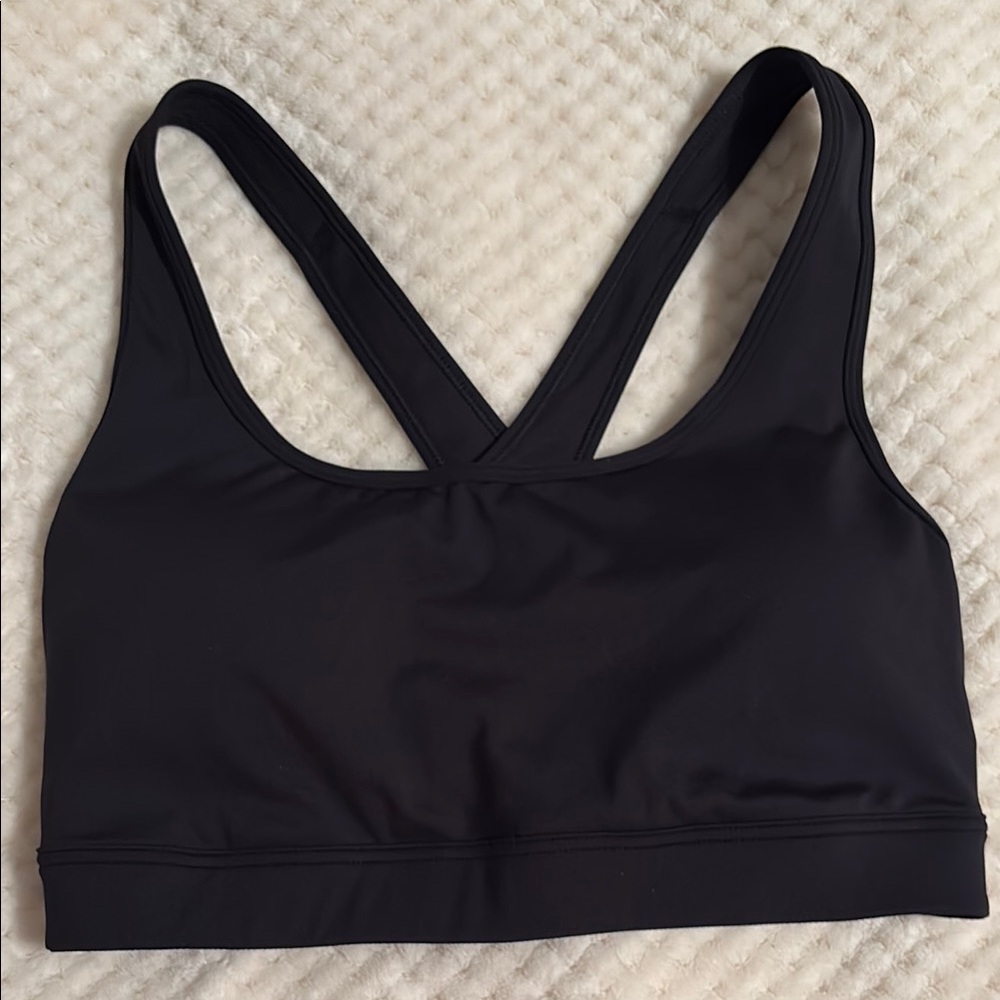 NWT. Black Sports Bra with padding/liner in size medium.